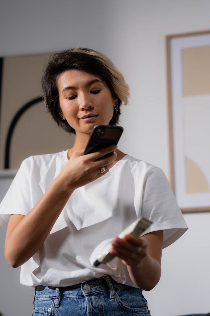 Woman Takes a Photo of a Cosmetic Tube